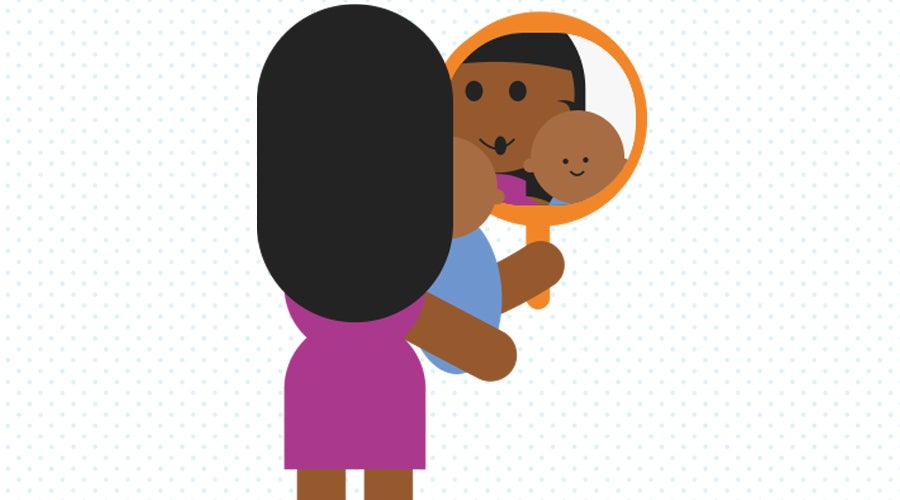 Mum and baby playing in the mirror together