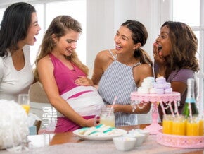  four woman playing a baby shower game