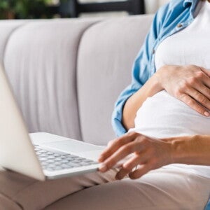 pregnant woman with laptop on her lap