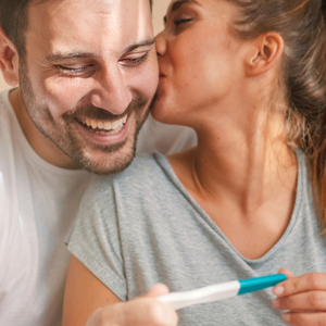 couple holding a pregnancy test