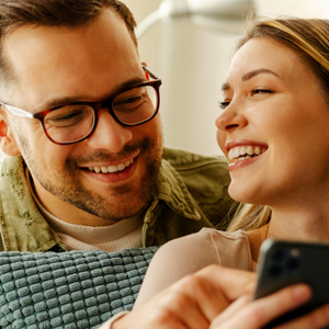 Couple looking at their mobile smiling