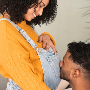 Man kissing pregnant womans stomach